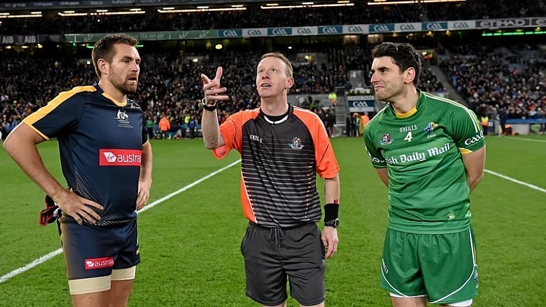 21 November 2015; Referee Joe McQuillan performs the coin toss between team captains Sam Mitchell, left, Australia and Bernard Brogan, Ireland, before the game. EirGrid International Rules Test 2015, Ireland v Australia. Croke Park, Dublin. Picture credit: Brendan Moran / SPORTSFILE