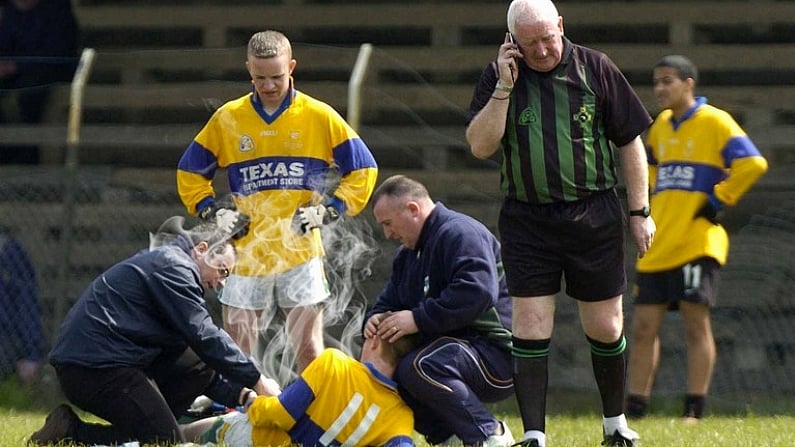 21 April 2005; Referee Fran Bolger phones for an ambulance after Nigel Dunne, Killina Presentation SS, received a serious injury. Leinster Vocational Schools Junior B Football Final, Colaiste Bhride, Carnew v Killina Presentation Secondary School, Geraldine Park, Athy, Co. Kildare. Picture credit; Damien Eagers / SPORTSFILE