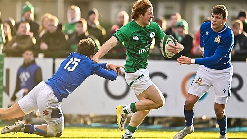 17 December 2022; Henry McErlean of Ireland evades the tackle of Tommaso Simoni of Italy, left, on his way to score his side's fourth try during the U20 Rugby International Friendly match between Ireland and Italy at Clontarf RFC in Dublin. Photo by Sam Barnes/Sportsfile