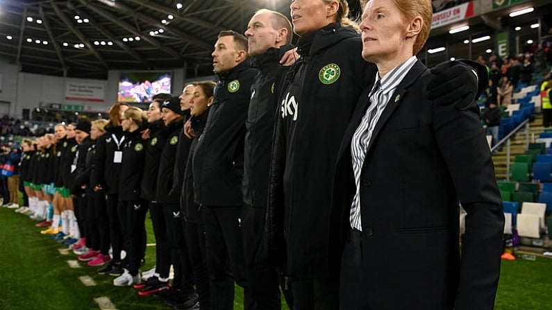 5 December 2023; Republic of Ireland interim head coach Eileen Gleeson and her coaching staff, from right, assistant coach Emma Byrne, assistant coach Colin Healy and goalkeeping coach Richie Fitzgibbon stand for the playing of the National Anthem before the UEFA Women's Nations League B match between Northern Ireland and Republic of Ireland at the National Football Stadium at Windsor Park in Belfast. Photo by Stephen McCarthy/Sportsfile