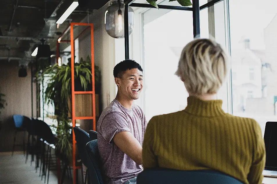 Two male friends chatting in a cafe