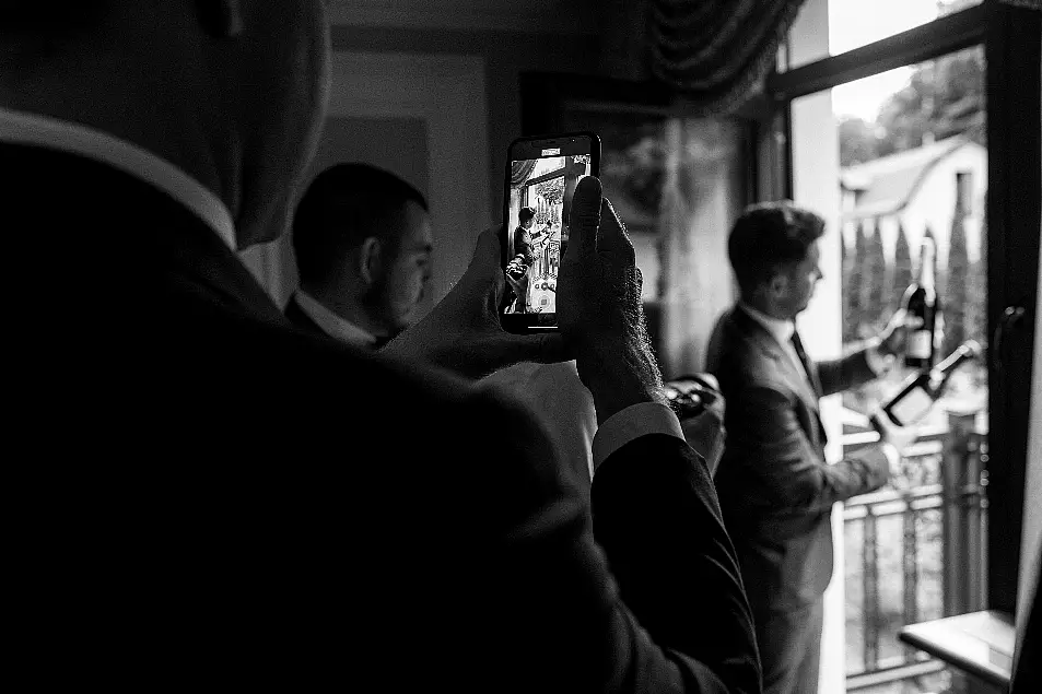 groom being photographed