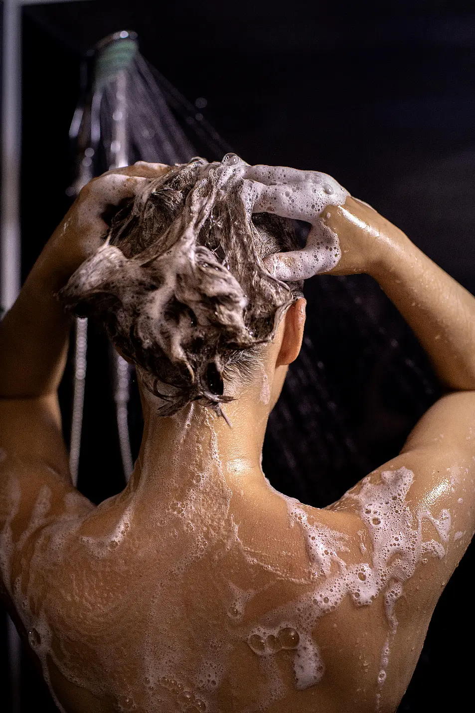 Woman shampooing hair