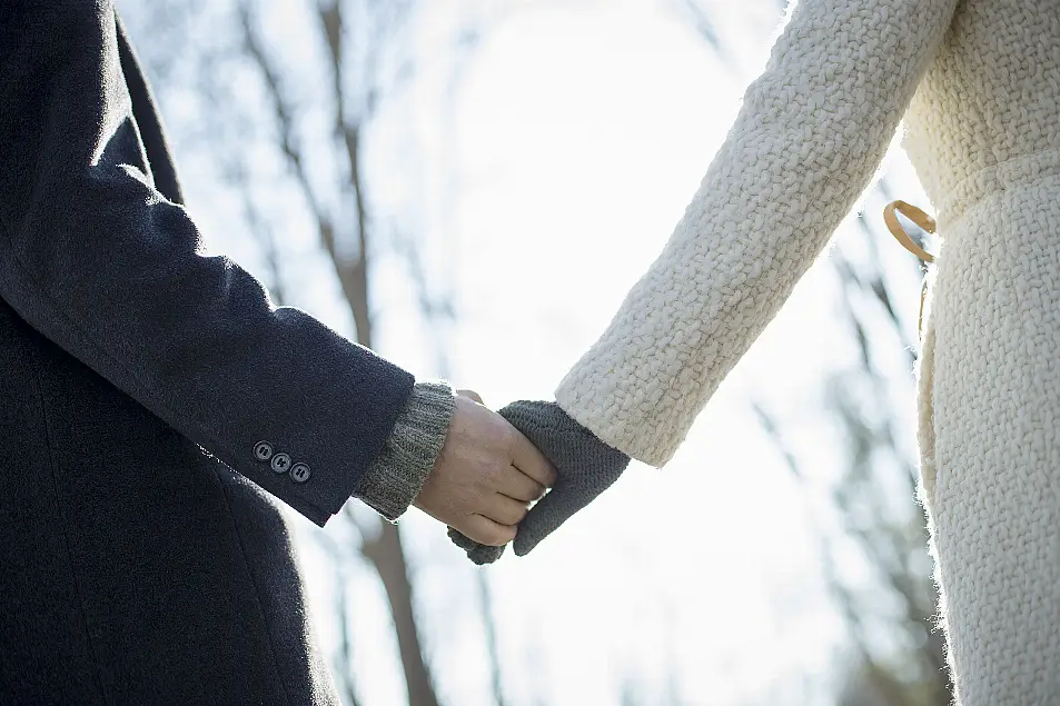 Couple holding hands on a winter walk