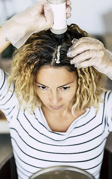 woman colouring her own hair