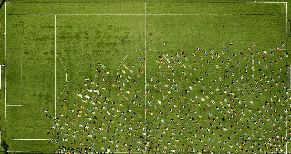 men praying on astroturf