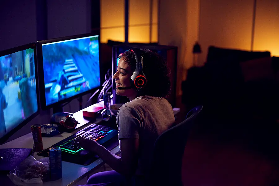 Teenager playing on multiple screens