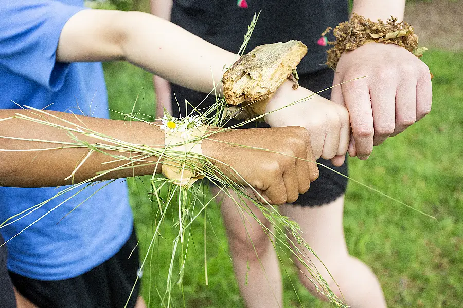 Children's wrists with nature bracelets on them (Soltan/PA)