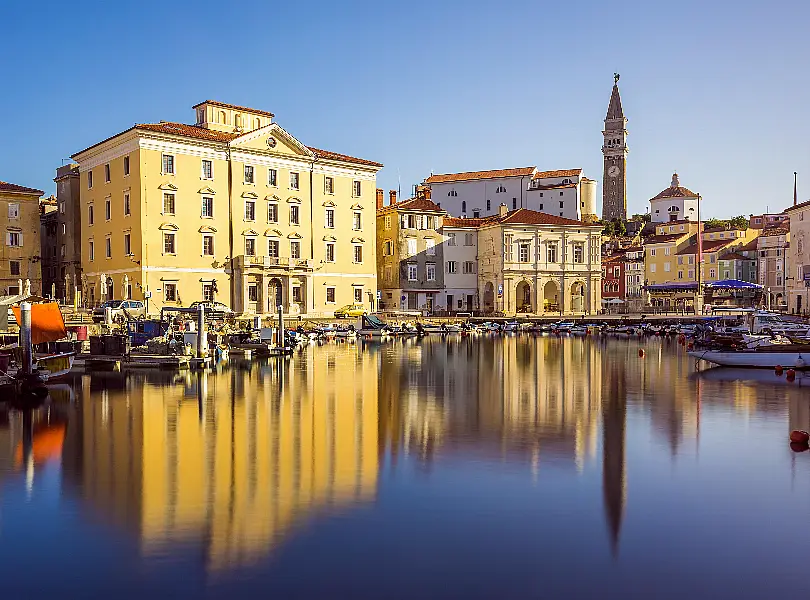 Main Square Tartini of Piran City reflected on water in Slovenia (Alamy/PA)