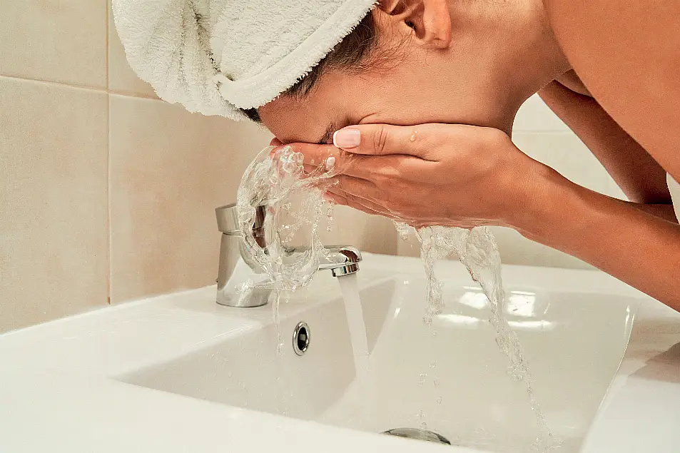 Woman washing her face