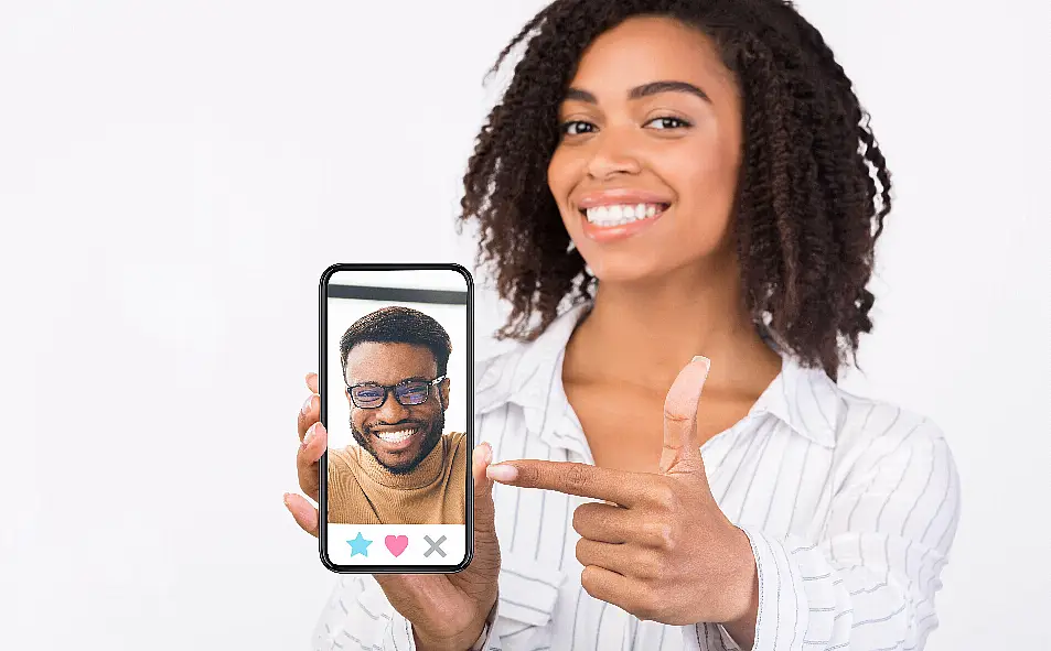 A woman using a dating app on a phone (Alamy/PA)