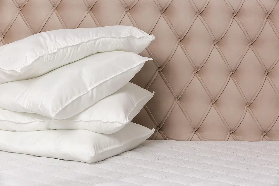 Pillows on mattress next to headboard