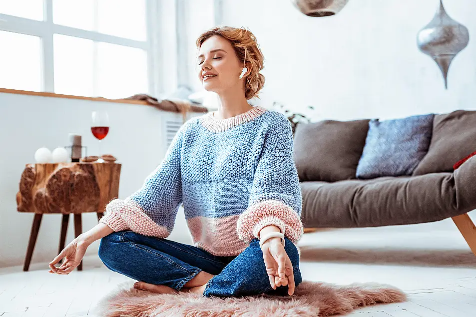 Young woman practicing yoga in her living room