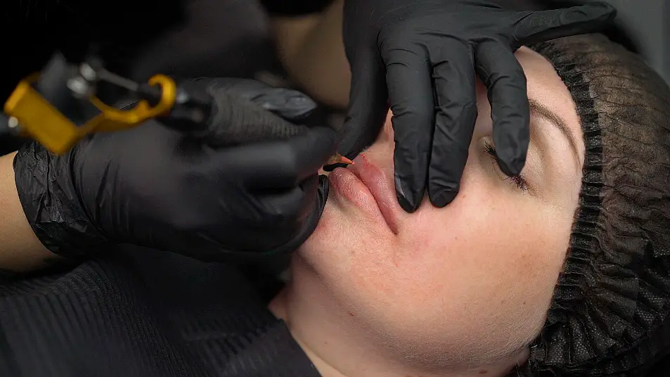 woman gets her lips permanently tattooed