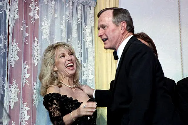 Actress Teri Garr is all smiles after being kissed by President Bush during a fundraising gala for the historic Ford’s Theatre in Washington on March 20 1991