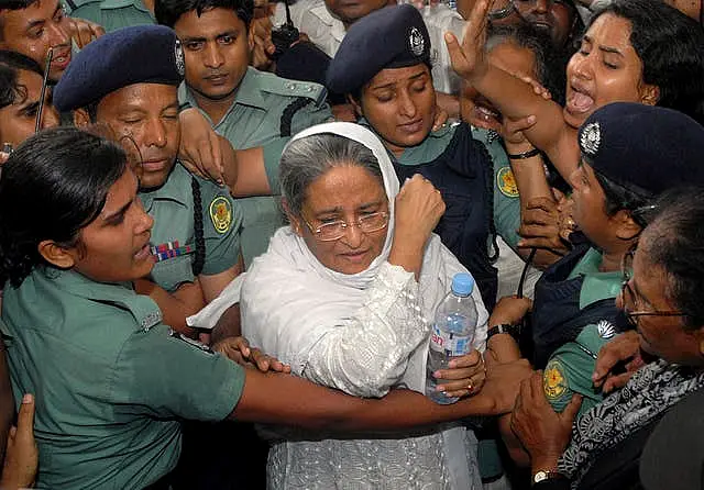 Police escort former Bangladeshi prime minister Sheikh Hasina (Abu Taher Khokon/AP)