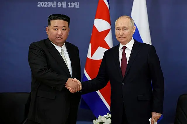 Russian President Vladimir Putin, right, and North Korean leader Kim Jong Un shake hands during their meeting at the Vostochny cosmodrome 