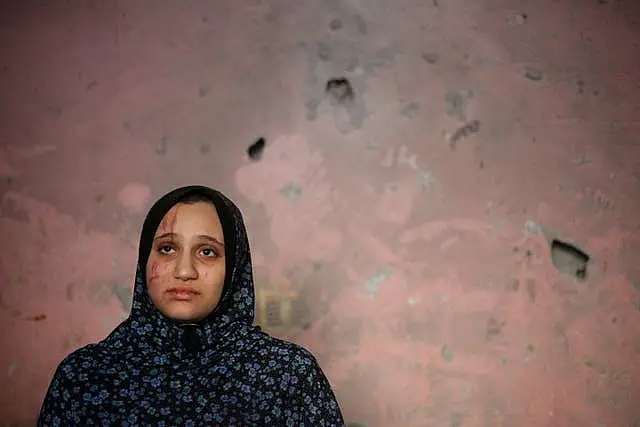 A woman in her devastated home