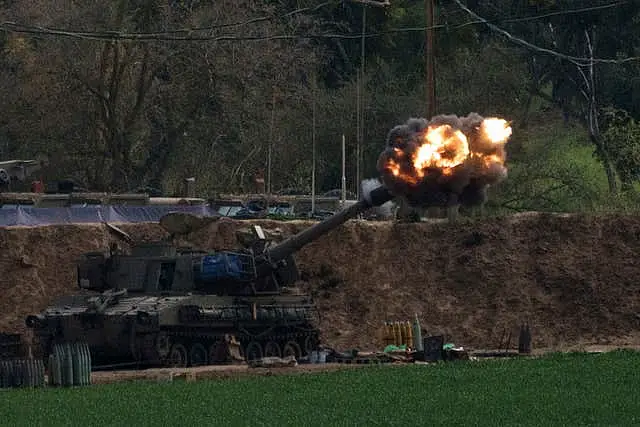 An Israeli mobile artillery unit fires a shell from southern Israel towards the Gaza Strip