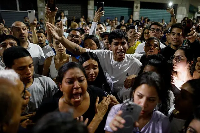 Supporters of opposition candidate Edmundo Gonzalez gather outside the Andres Bello School voting centre asking for the results