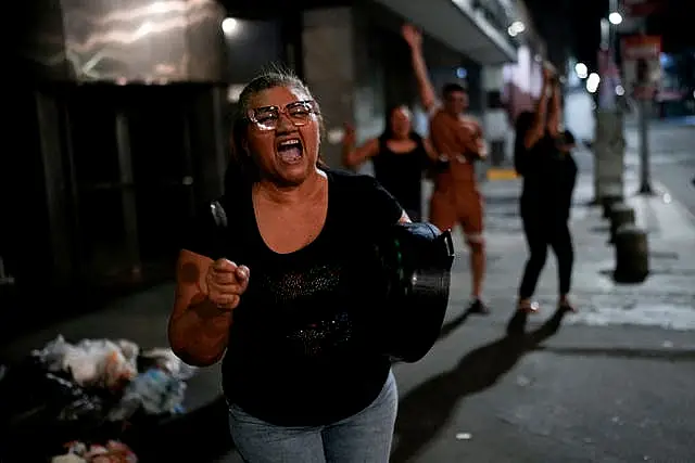 Supporters of opposition candidate Edmundo Gonzalez bang pots after the polls closed for the presidential election in Caracas