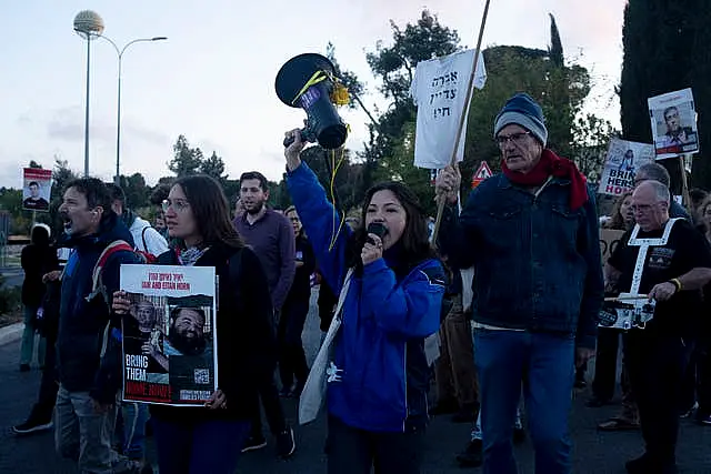 Relatives of hostages held in Gaza and their supporters move into an intersection to protest outside the Prime Minister’s office to call for an immediate release of the captives for the Jewish holiday of Passover as the war cabinet meets in Jerusalem