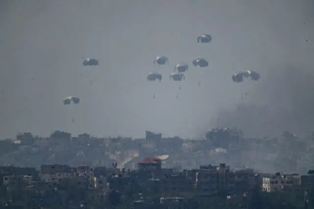 Parachutes drop supplies into the northern Gaza Strip as seen from southern Israel