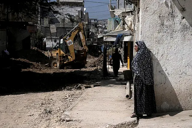 A Palestinian woman watches an operation by the Israeli military in Tulkarem refugee camp in the West Bank