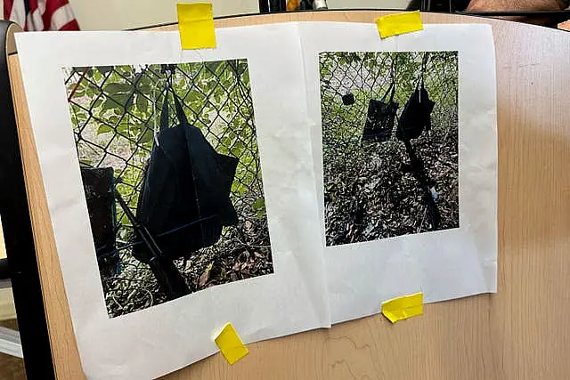 Photos that show an AK-47 rifle, a backpack and a Go-Pro camera on a fence outside Trump International Golf Club taken after an apparent assassination attempt of Republican presidential candidate Donald Trump are displayed during a news conference at the Palm Beach County Main Library in West Palm Beach, Florida