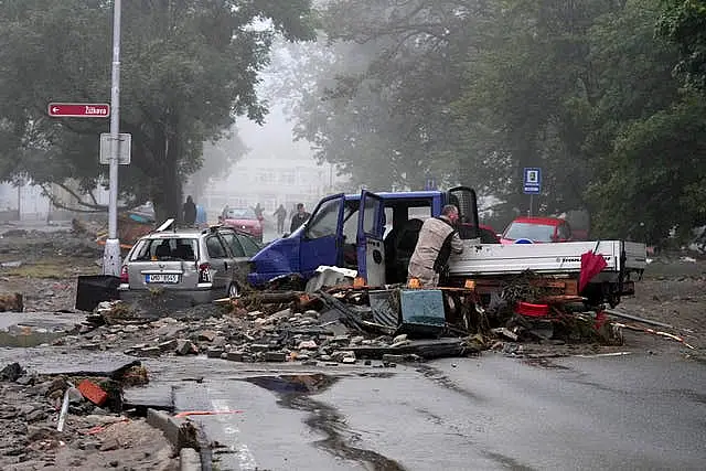 A resident looks at his damaged car after recent floods in Jesenik, Czech Republic