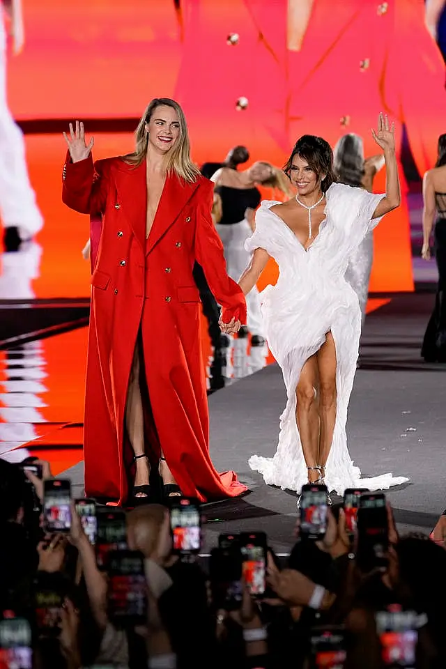 Cara Delevingne, left, and Eva Longoria wear creations as part of the L’Oreal Spring/Summer 2025 collection presented Monday, Sept. 23, 2024 in Paris