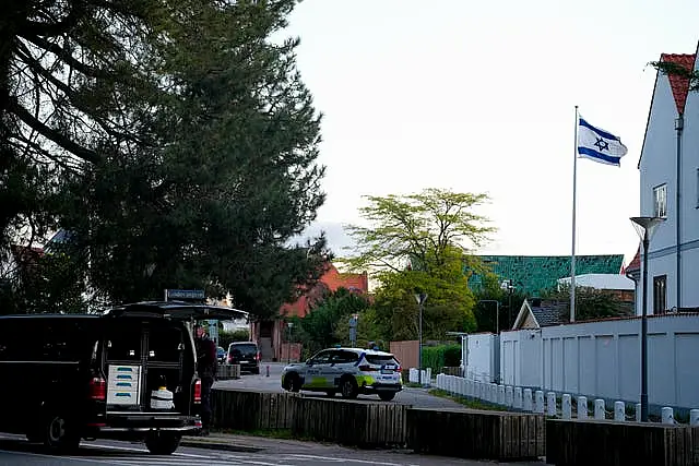 A police vehicle is seen near the Israeli embassy in Copenhagen, as police investigate two explosions near the site 