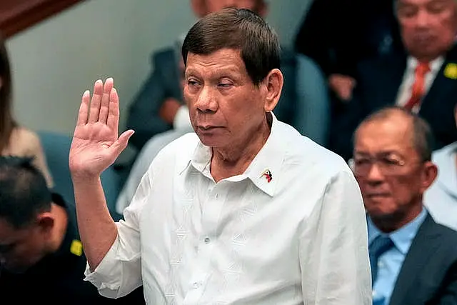 Rodrigo Duterte raises his hand to make an oath