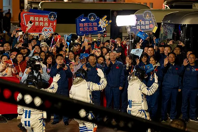 Chinese astronauts Wang Haoze, from left, Song Lingdong and Cai Xuzhe wave during the see-off ceremony for the Shenzhou-19 mission at the Jiuquan Satellite Launch Centre in northwestern China