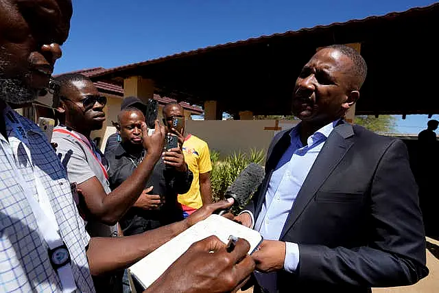 Umbrella for Democratic Change (UDC) presidential candidate Duma Boko speaks to journalist after casting his vote during the elections in Gaborone 