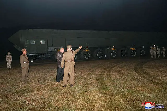 North Korean leader Kim Jong Un, second right, observes what the country's government says was a test launch