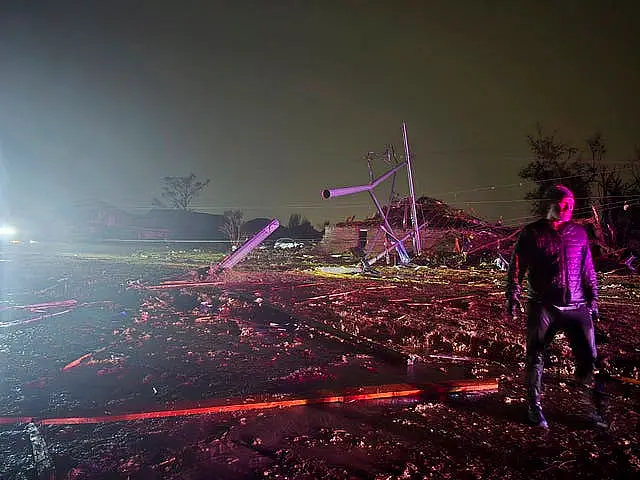 A person surveys the damage after a tornado