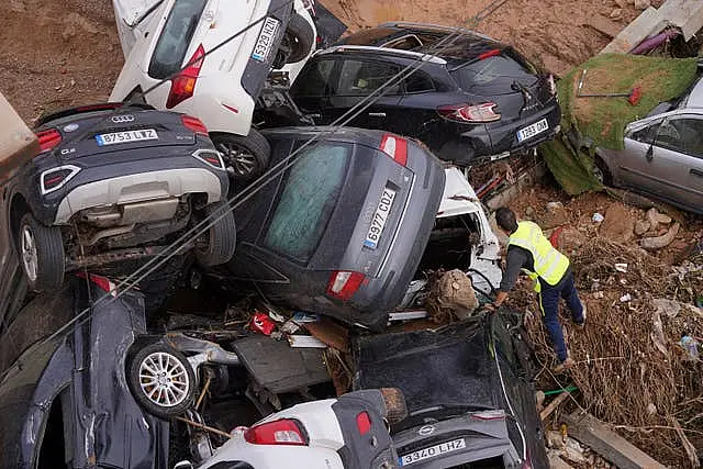 A civil guard searches for survivors in cars