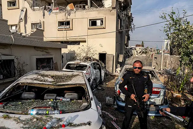 Damaged cars and a destroyed building 