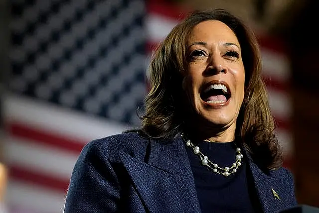 Kamala Harris gives a speech before the stars and stripes