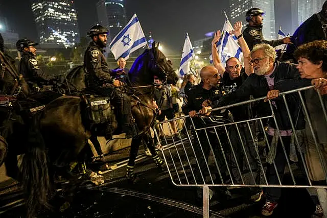 Israeli police try to push back protesters from a main road in Tel Aviv after Prime Minister Benjamin Netanyahu dismissed his defence minister Yoav Gallant in a surprise announcement 