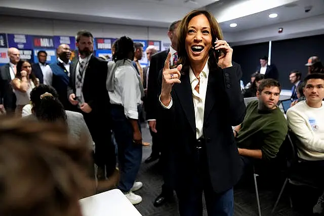 Democratic presidential nominee Kamala Harris, right, phone banks with volunteers at the DNC headquarters on Election Day in Washington 