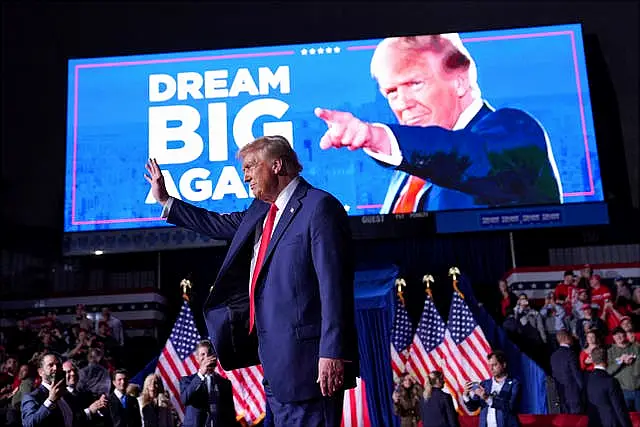 Donald Trump waves at a campaign rally