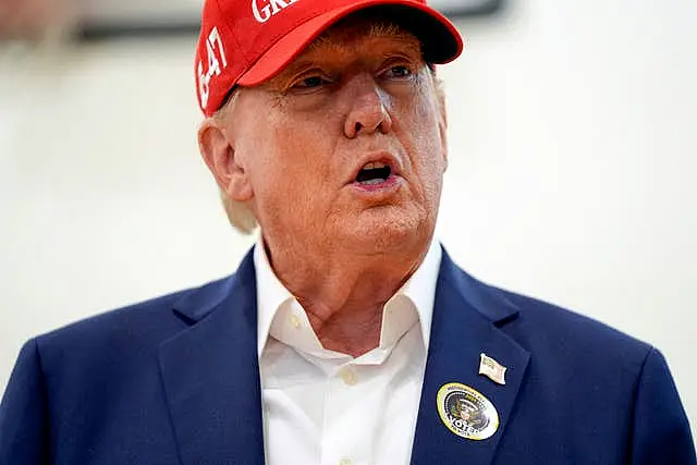 Donald Trump wearing a red MAGA hat