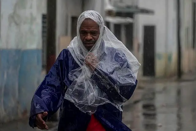 A man walks through the wind and rain 