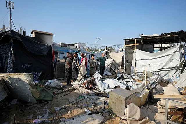 Palestinians gather at the site of an Israeli strike in the courtyard of the Al-Aqsa Hospital