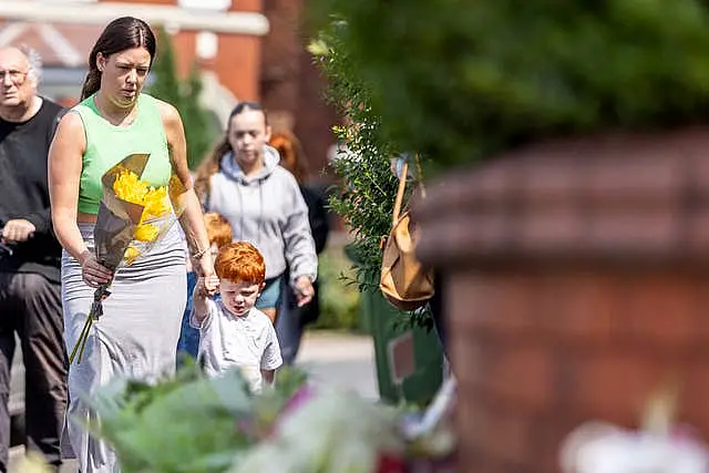 A woman and child holding flowers 