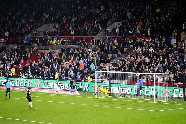 Brentford goalkeeper Mark Flekken, right, saves a penalty in the shoot-out from Sheffield Wednesday’s Liam Palmer