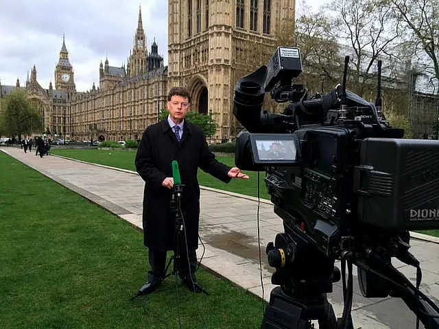 David Davin-Power presenting in front of TV camera