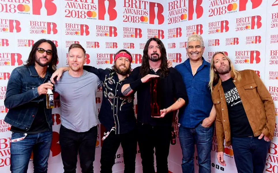 Foo Fighters with their award for Best International Group in the press room during the Brit Awards